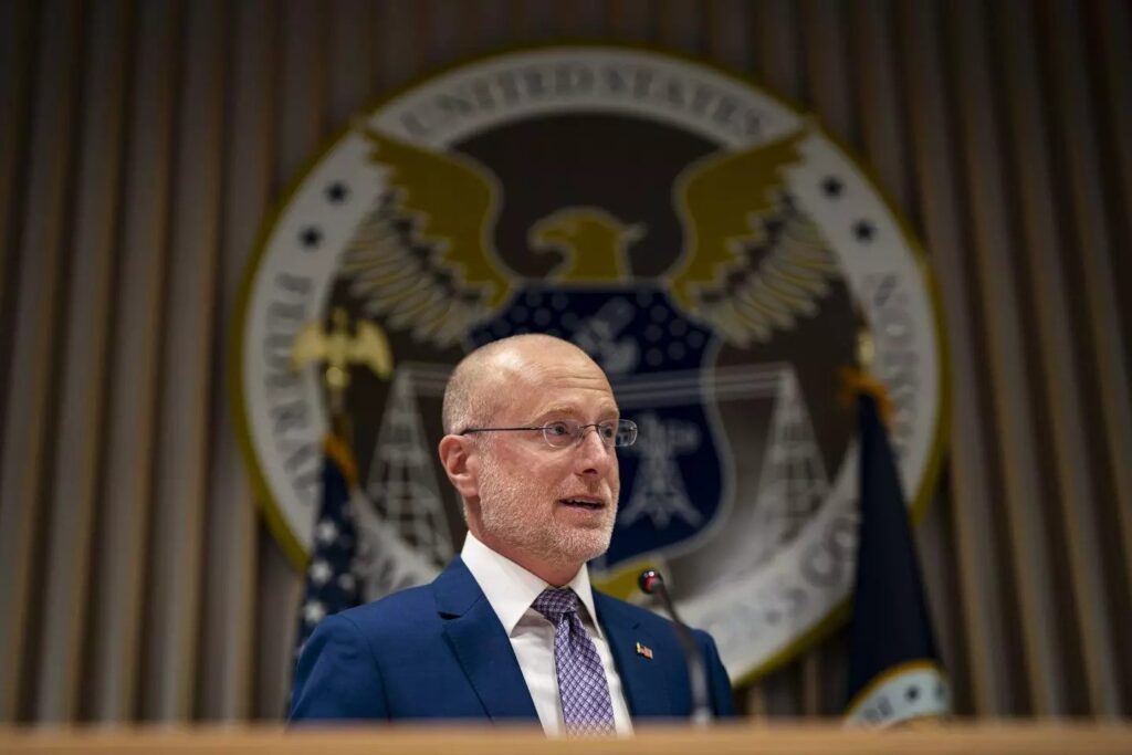 Man speaking at podium with US government seal